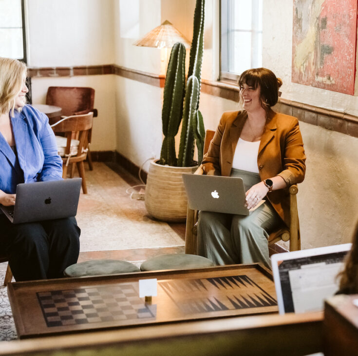 three women working together on computers